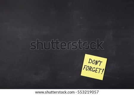 Don't forget inscription on colorful stickers on blackboard