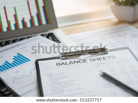 accounting concept. balance sheet and business earning report on desk.