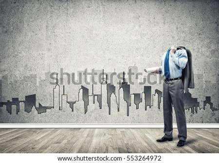 Headless engineer man with papers in hand against construction background