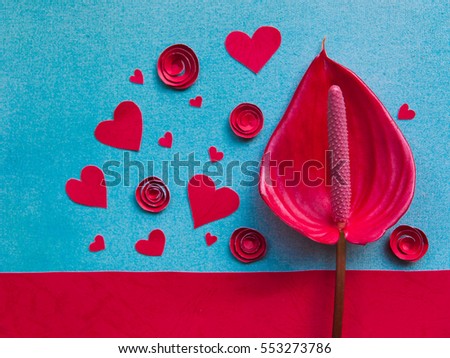 Overhead flat lay valentine day background. Red paper hearts and flowers handmade, kraft envelope letters with kiss print on blue textured background. Bright inspiration for holiday of love.