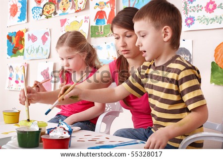 Children painting with teacher in art class. Child care. Royalty-Free Stock Photo #55328017