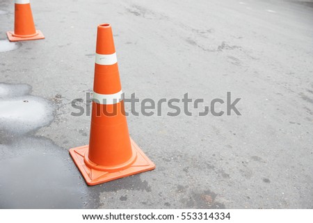 Background of orange traffic cone for warning wet street with copy-space