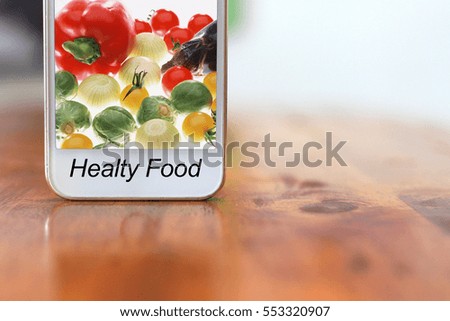 HEALTY FOOD word with the image in a telephone