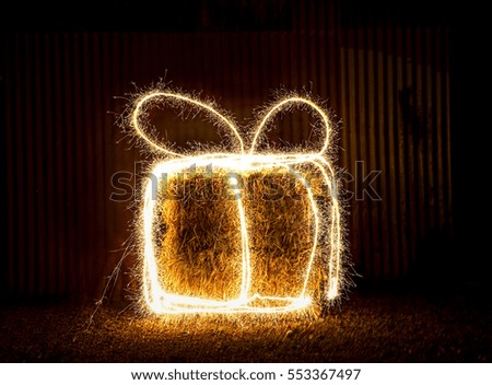 Light Painting On A Hay Bale To Create An Image Of A Gift
