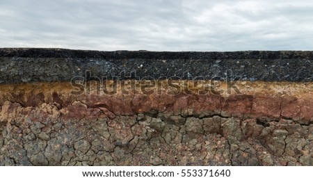 The layer of asphalt road with soil and rock. Un-focus image. Royalty-Free Stock Photo #553371640
