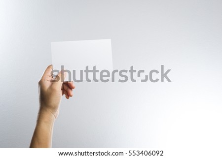 Hand hold blank photo paper card  on white background