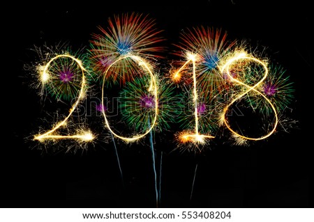 HAPPY NEW YEAR 2018 from colorful sparkle on black background Fireworks light up the sky,New Year celebration fireworks Royalty-Free Stock Photo #553408204