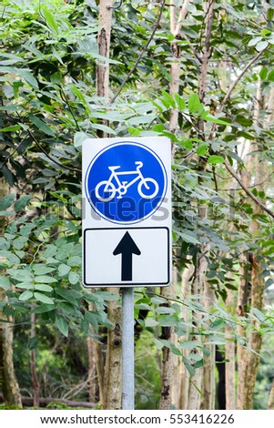 Sign in road for bicycle in the park.