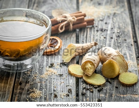 still life with transparent and fragrant Cup of tea with ginger on wooden background