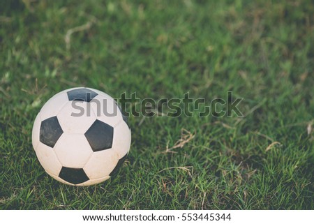 A soccer football on the green grass. Film picture style.
