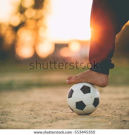 kids are playing soccer football for exercise under the sunlight. Film picture style.