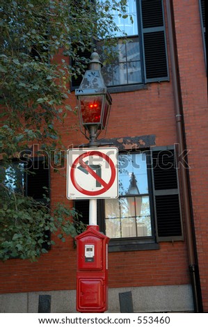 Red gas lit Lamppost and fire box with reflects on window house  in Beacon Hill, Boston, Massachusetts