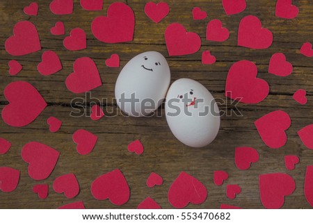 Unusual two eggs in love with the muzzle and red hearts