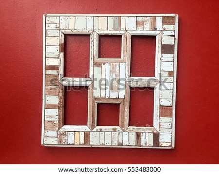 Picture frame from wood. Photo art gallery on red vintage wall.