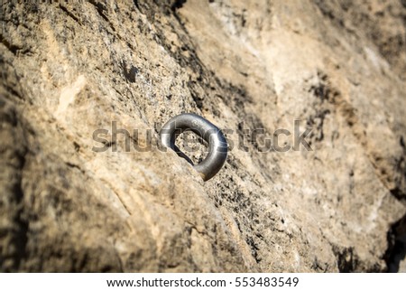 Anchor climbing on a rock wall. Old rusty iron piton. Rock climbing hook. Color picture of a fastening screw for climbing on a stone wall