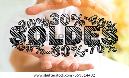 Businessman on blurred background holding sales icons in his hand 3D rendering ("soldes" means "sales in french)