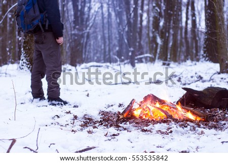 winter forest, the tourist warm tea in a pot, snow