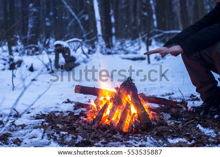 winter forest, the tourist warm tea in a pot, snow