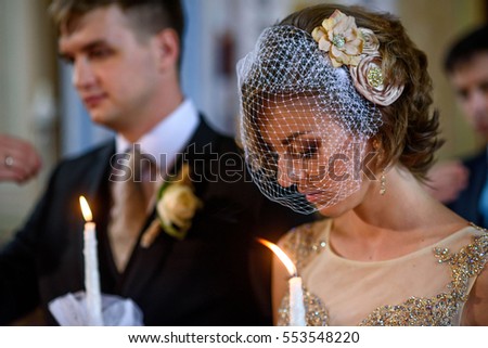young bride and groom standing in church on the wedding ceremony
