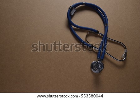 Stethoscope on brown background with space for text - health concept. Medical conceptual