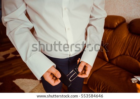 businessman dressed for work.businessman puts on a shirt