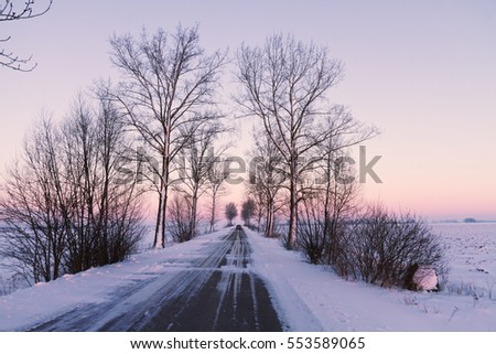 Landscape - Beautiful winter morning or afternoon. Polish winter road between fields with snow and good weather.