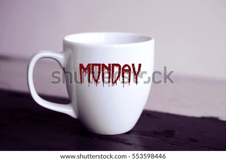 white cup with the word Monday written in bloody letters