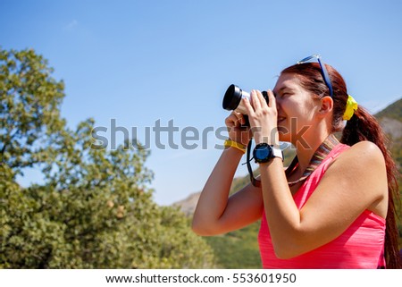 Woman taking pictures background mountain