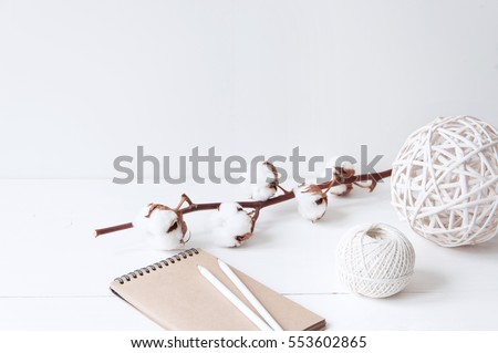 Minimal elegant composition with cotton, balls and notebook