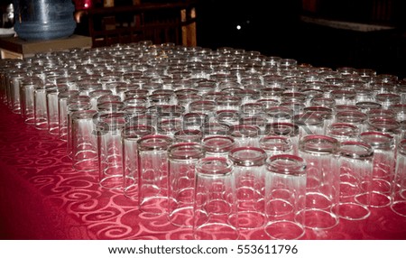 Several lines of glasses at the table for the guests
