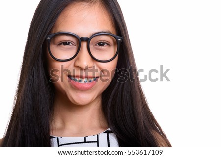 Young happy Asian teenage nerd girl smiling isolated against white background