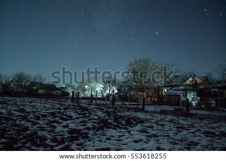 Winter starry sky in the village