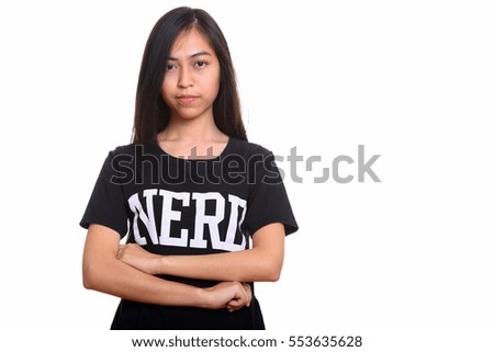 Studio shot of young Asian teenage nerd girl with arms crossed isolated against white background