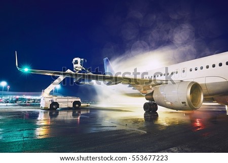 Airport in winter. Deicing of the airplane before flight.