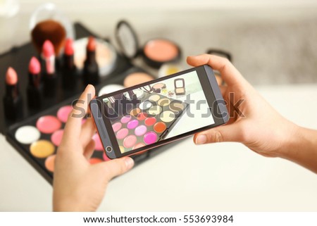 Photo of makeup kit on mobile phone display while shooting