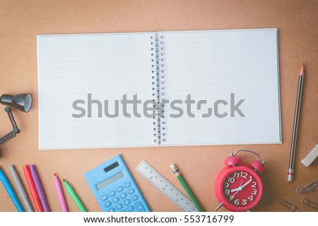 blank space note book , stationery and alarm clock for education and office concept background