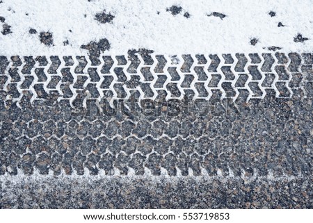 tire track on snow in the street