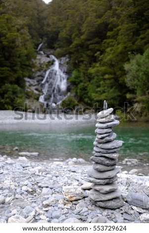 Balanced Rock Zen Stack in front of waterfall