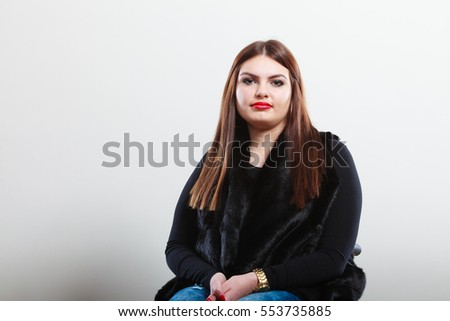Young beauty woman portrait. Pensive attractive brunette wearing dark black clothes.