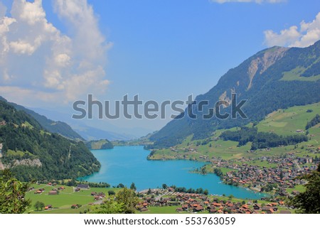 The picture was taken in the Swiss Alps. The picture shows one of the picturesque villages located on the shores of the azure lake.