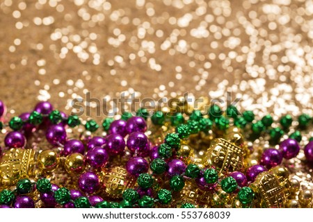 Mardi Gras Beads on Gold Glitter