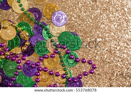Mardi Gras Coins and Beads on Gold Glitter