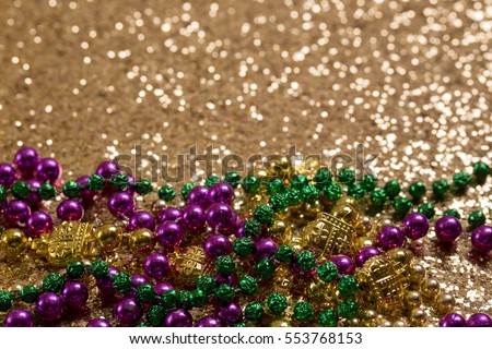 Mardi Gras Beads on Gold Glitter