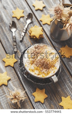 cup of hot cocoa flavored cookies with the stars on a wooden table, selective focus, top view