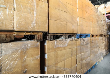 Warehouse transport and logistics company. A stack of cardboard boxes. Cardboard boxes wrapped in stretch film.