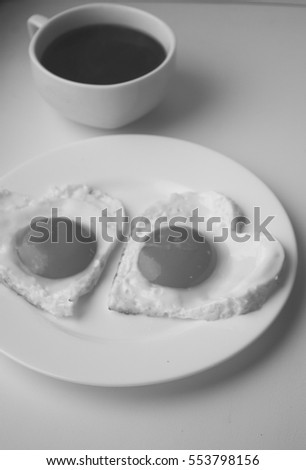Breakfast on Valentine's Day-fried eggs in the shape of a heart,coffee.Valentine background with pink rose.Top view.Happy lovers day.Mother's Day.Valentine's day concept.Valentines day card