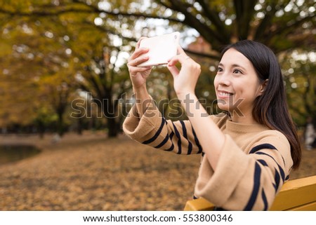 Woman taking photo at park