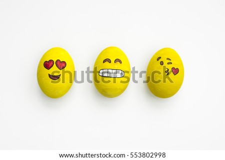 Painted Easter eggs in different moods and facial expression such as kissing, smiling or being in love, in isolated white background.