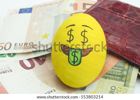 Emoji Easter egg with facial expression "I love money" placed on euro paper money.