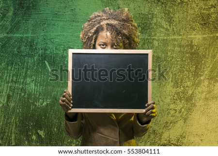Young black girl with blackboard